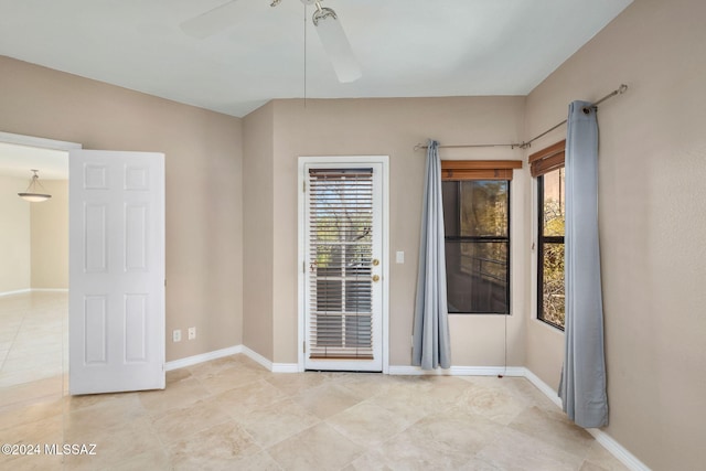 tiled empty room with ceiling fan