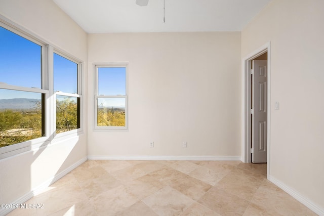 unfurnished room with ceiling fan