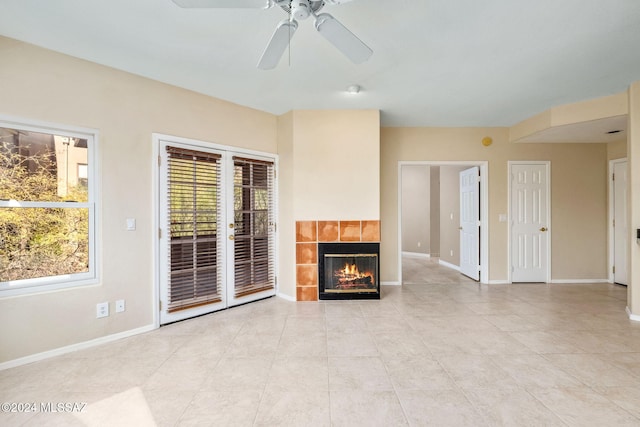 unfurnished living room with light tile patterned flooring, ceiling fan, and a tiled fireplace