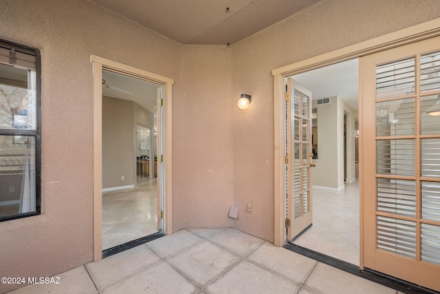 hallway featuring light tile patterned floors