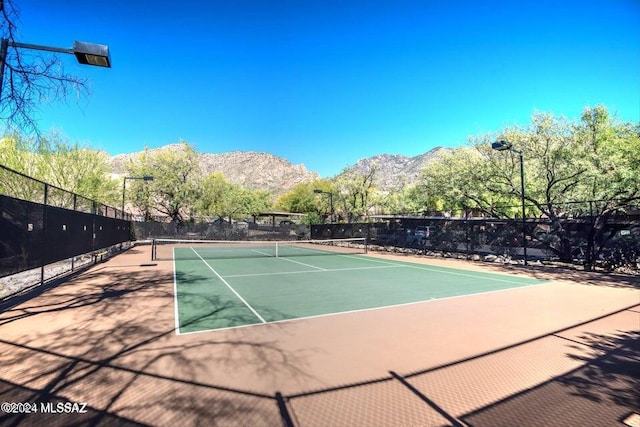 view of sport court featuring a mountain view and basketball court