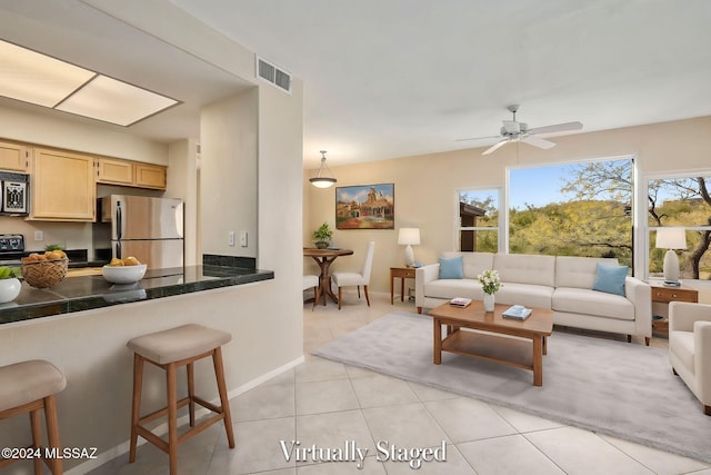 tiled living room with ceiling fan