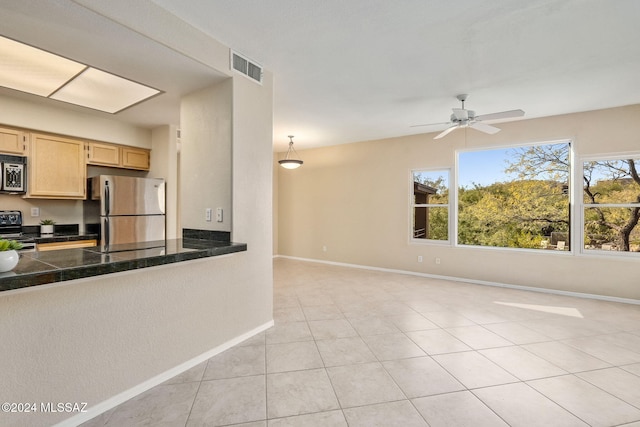 kitchen featuring stainless steel refrigerator, ceiling fan, black range oven, light brown cabinetry, and light tile patterned flooring