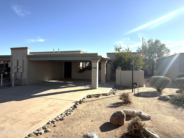 back of property with a carport