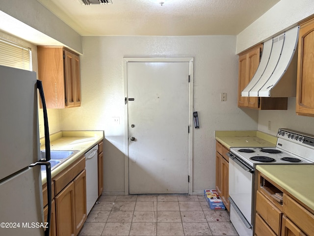 kitchen featuring white appliances and extractor fan