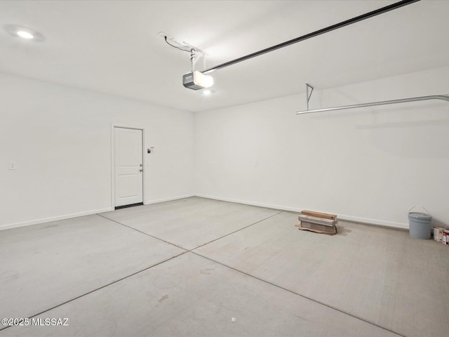 garage featuring a garage door opener and baseboards