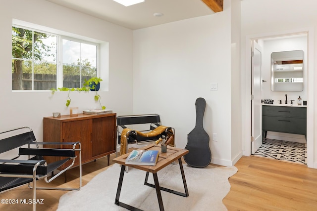 sitting room featuring sink and light hardwood / wood-style floors