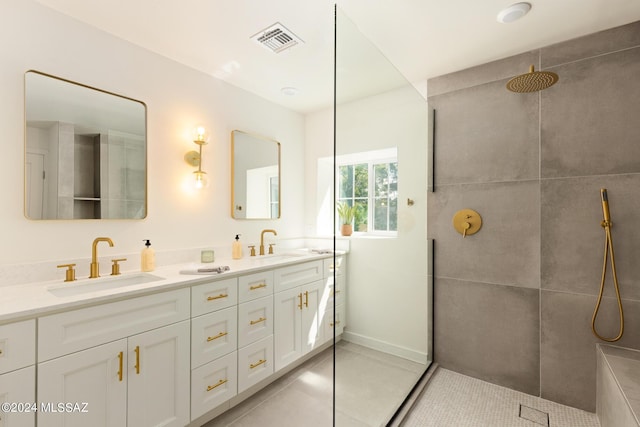 bathroom featuring double vanity, visible vents, a walk in shower, and a sink