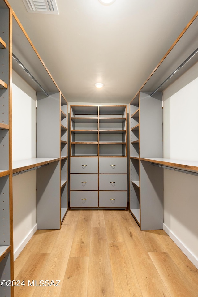 walk in closet with light wood-style floors and visible vents