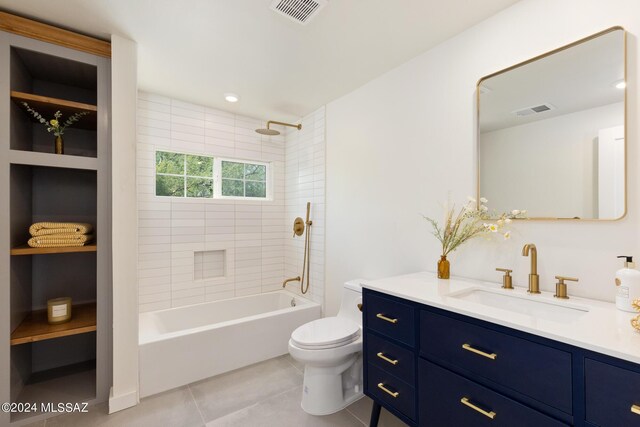 bathroom with toilet, vanity, tile patterned flooring, and visible vents