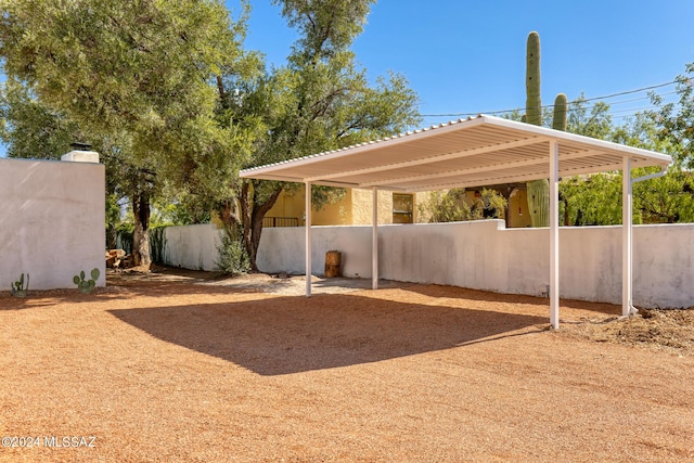 view of yard featuring a carport and fence