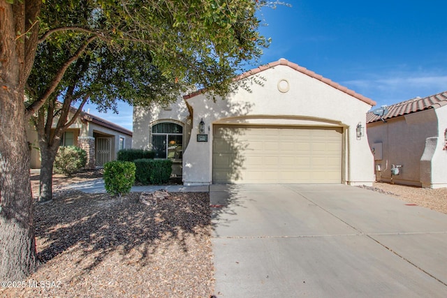 mediterranean / spanish-style house with a garage