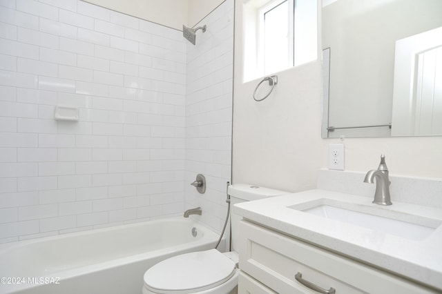 full bathroom featuring vanity, toilet, and tiled shower / bath