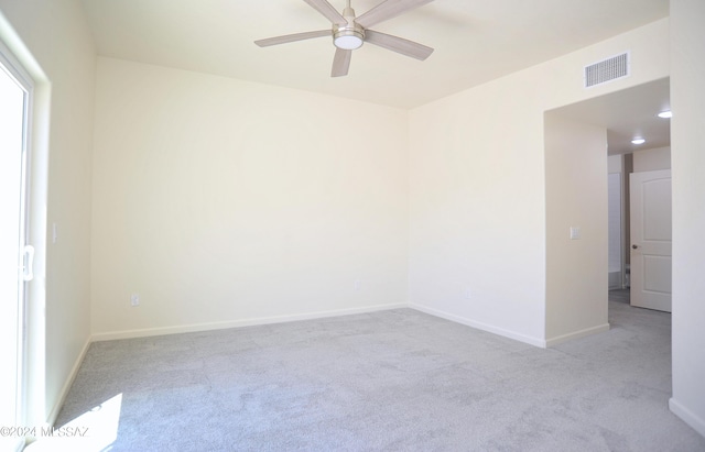 spare room with light carpet and ceiling fan