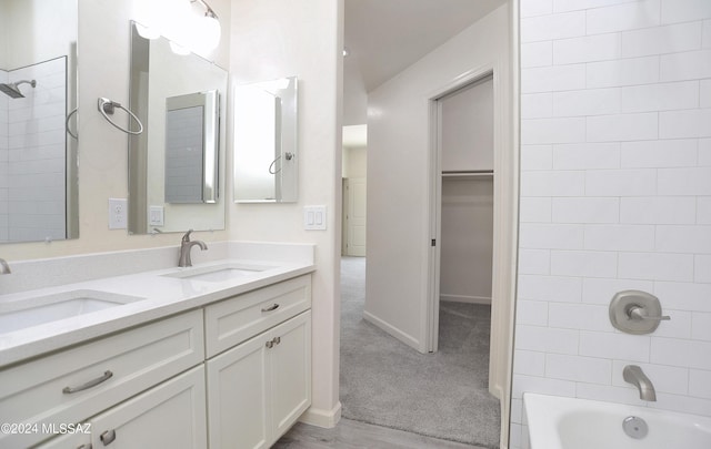 bathroom featuring vanity and tiled shower / bath combo