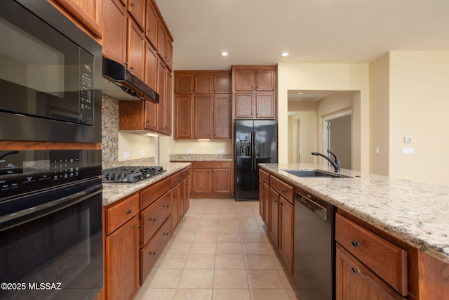 kitchen featuring light stone countertops, sink, tasteful backsplash, light tile patterned floors, and black appliances