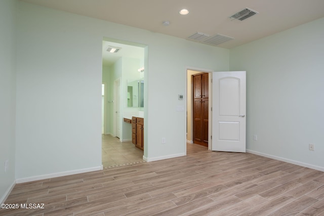 spare room featuring light hardwood / wood-style floors