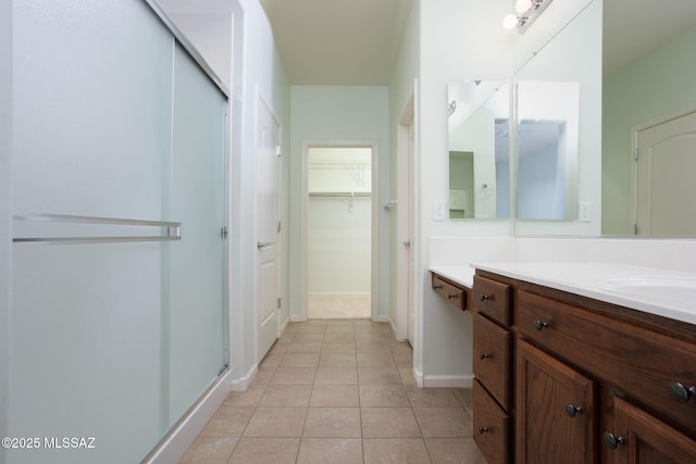 bathroom featuring tile patterned floors, vanity, and walk in shower