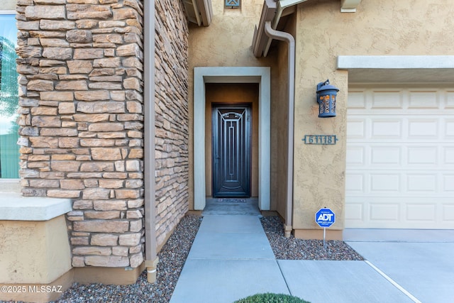 doorway to property featuring a garage