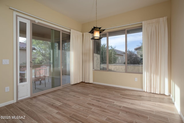 unfurnished room with light wood-type flooring