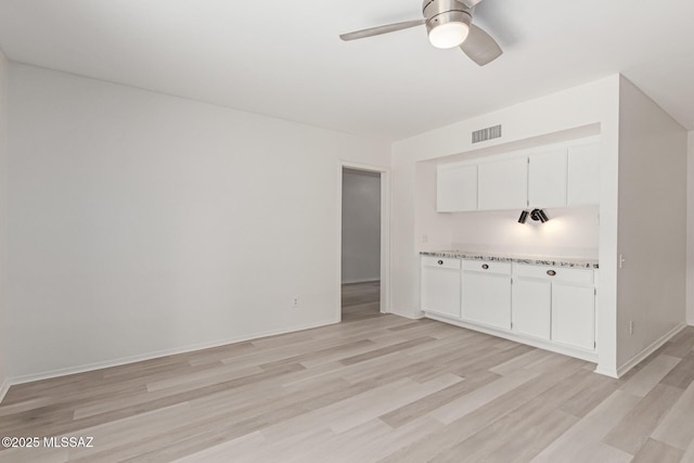 interior space with ceiling fan and light hardwood / wood-style floors