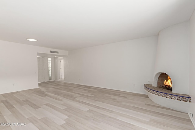 unfurnished living room featuring light hardwood / wood-style flooring