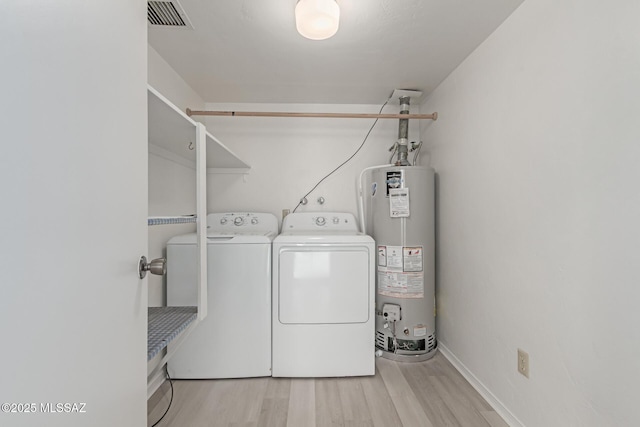 laundry area with separate washer and dryer, gas water heater, and light hardwood / wood-style flooring