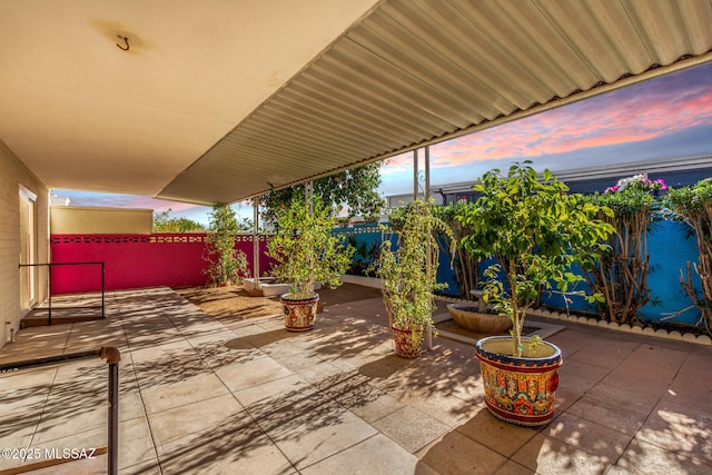 view of patio terrace at dusk