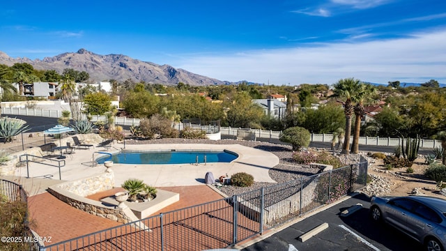 view of swimming pool featuring a mountain view and a patio