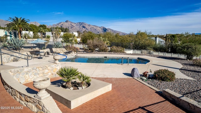 view of pool featuring a mountain view and a patio