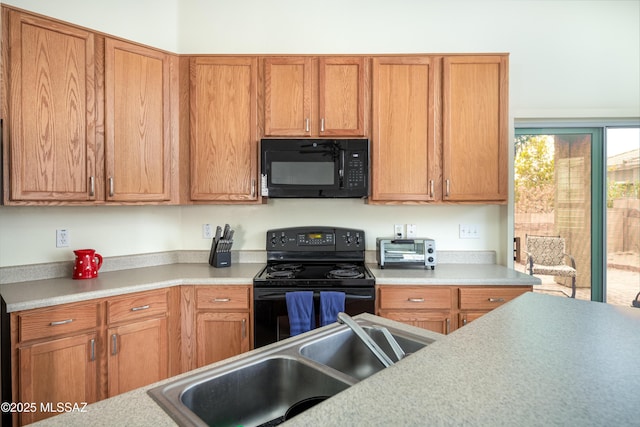 kitchen with sink and black appliances