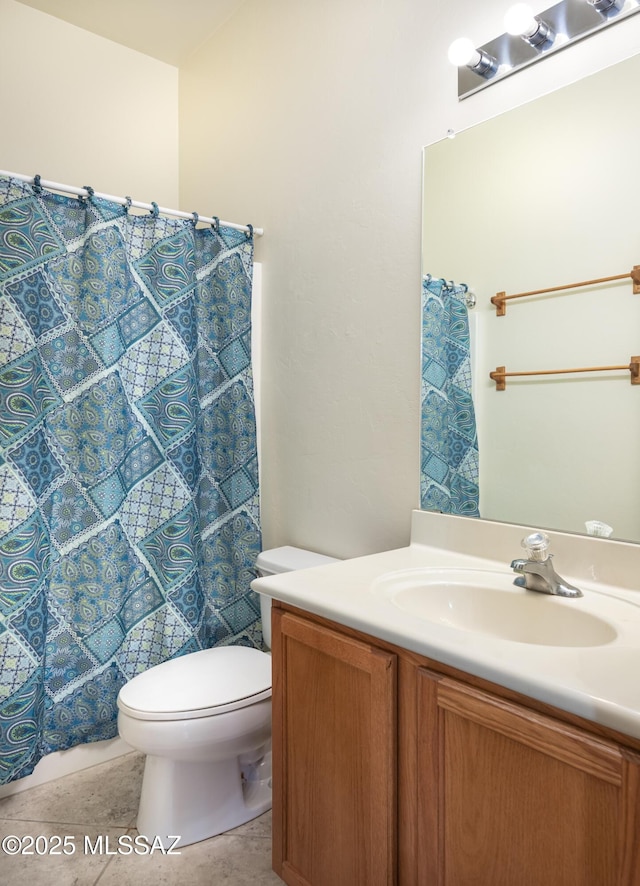 bathroom featuring tile patterned floors, vanity, and toilet