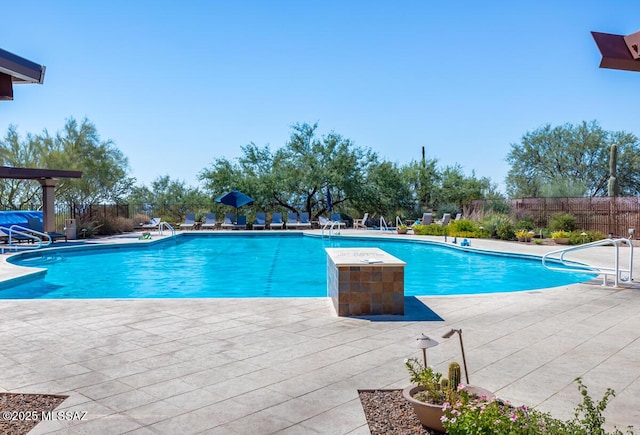 view of swimming pool featuring a patio area