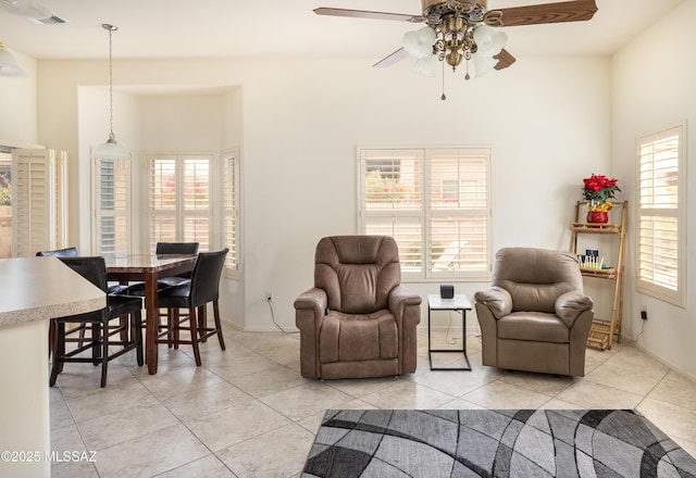 tiled living room with ceiling fan