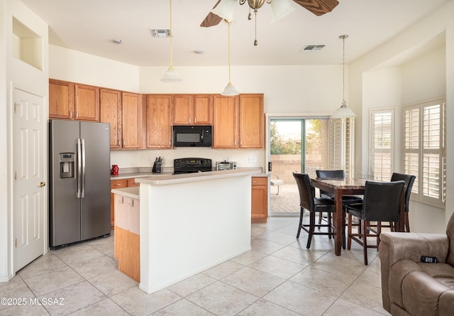 kitchen with a center island, stove, ceiling fan, decorative light fixtures, and stainless steel fridge with ice dispenser