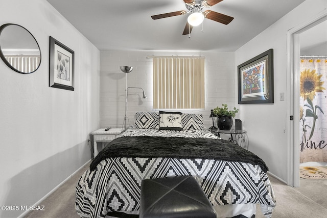 carpeted bedroom with connected bathroom and ceiling fan