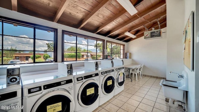 clothes washing area featuring washer and clothes dryer, light tile patterned flooring, and wood ceiling