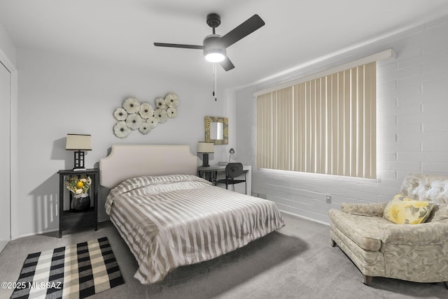 carpeted bedroom featuring ceiling fan and brick wall