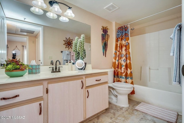 full bathroom with vanity, shower / bath combo, and toilet