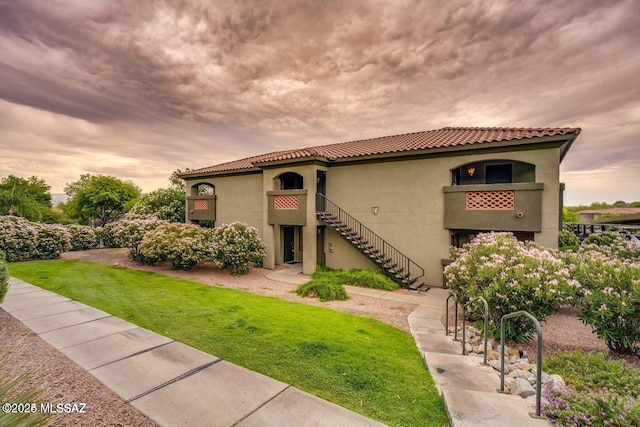 mediterranean / spanish-style home with a yard