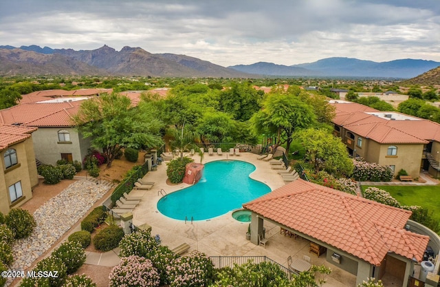 view of pool with a mountain view and a patio