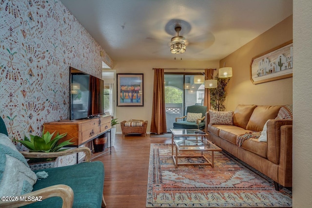 living room featuring ceiling fan and hardwood / wood-style floors