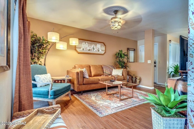 living room with hardwood / wood-style floors and ceiling fan