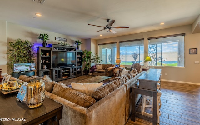 living room with hardwood / wood-style flooring and ceiling fan