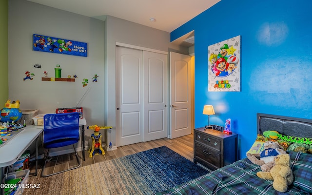 bedroom with light wood-type flooring and a closet