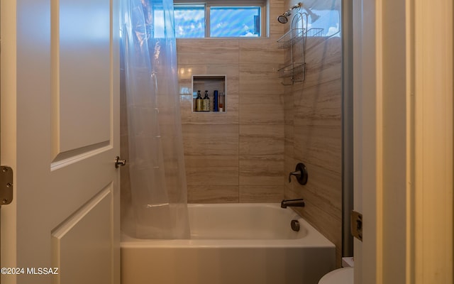 bathroom with shower / bathtub combination with curtain and toilet