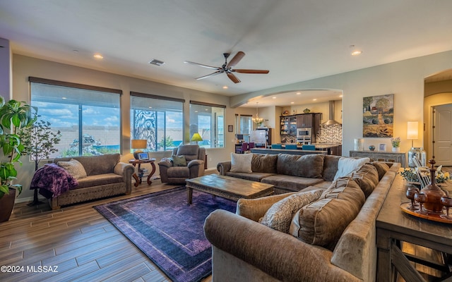 living room featuring ceiling fan and hardwood / wood-style floors