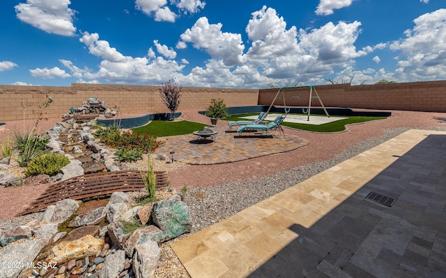 view of yard with a playground and a patio area