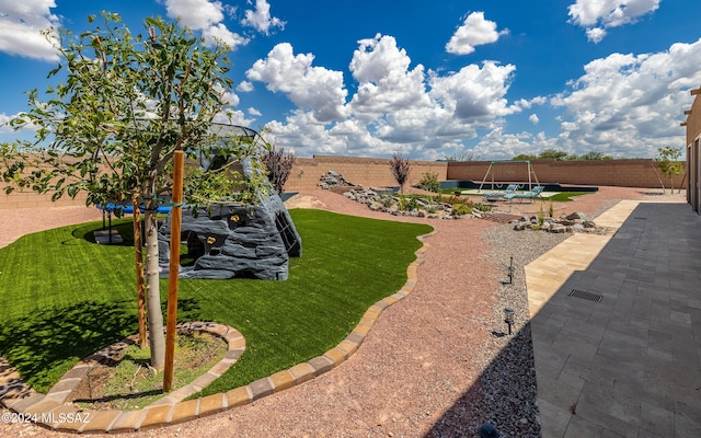 view of yard with a trampoline