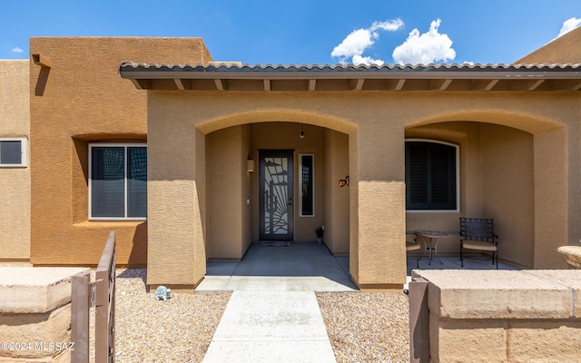 doorway to property with a patio area